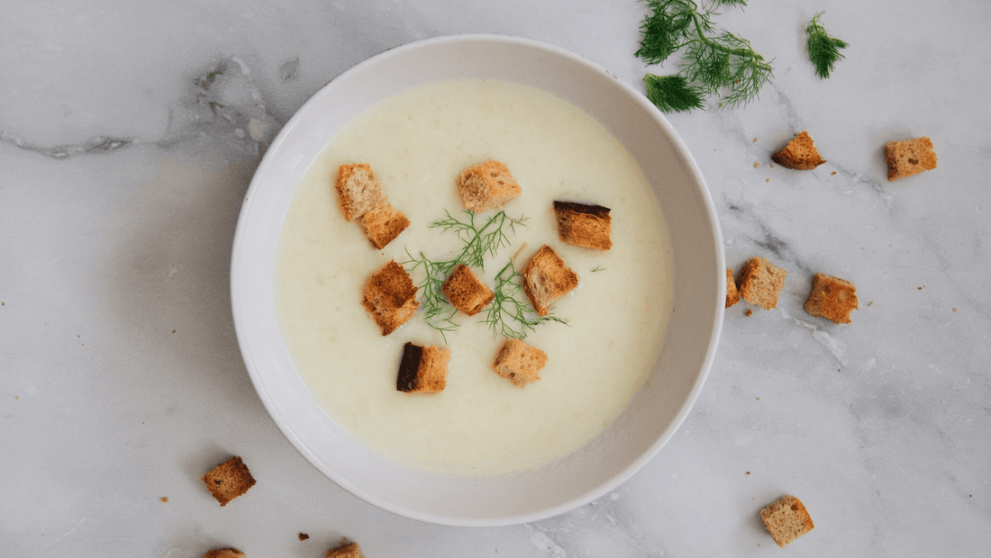 Bowl of creamy vegetable soup topped with croutons and fresh herbs, made with organic vegetables and organic food delivery in Brisbane