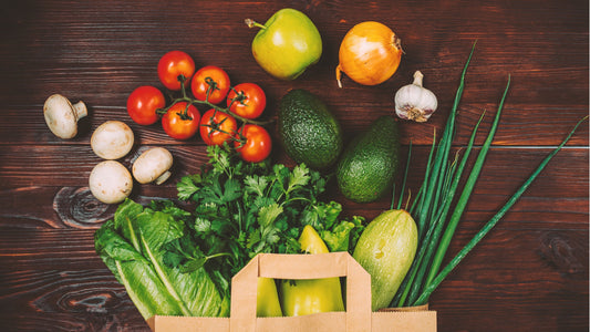 Fresh seasonal vegetables and wholefoods in a reusable grocery bag
