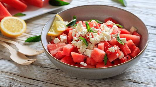Fresh watermelon and fetta salad topped with mint and served with lemon wedges.