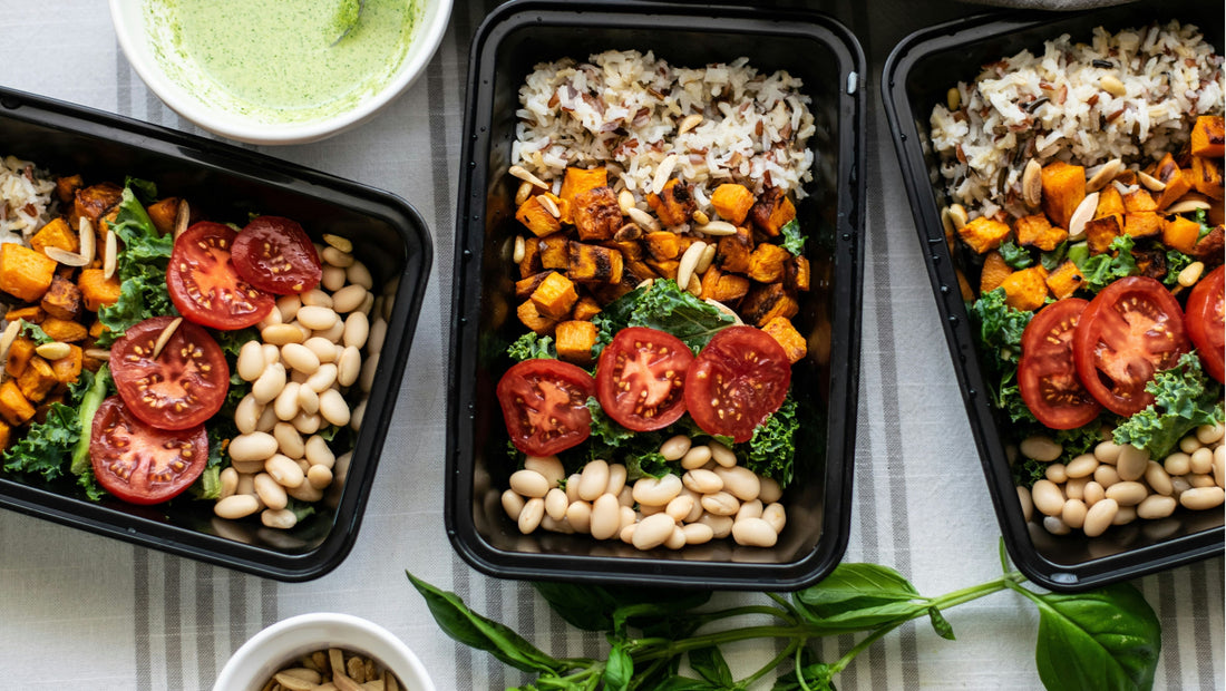 Organic ready-made meals and meal prep containers filled with roasted sweet potato, kale, tomatoes, beans and rice, showcasing healthy meal delivery made with fresh local produce from Joy Wholefoods Brisbane.
