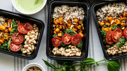 Organic ready-made meals and meal prep containers filled with roasted sweet potato, kale, tomatoes, beans and rice, showcasing healthy meal delivery made with fresh local produce from Joy Wholefoods Brisbane.