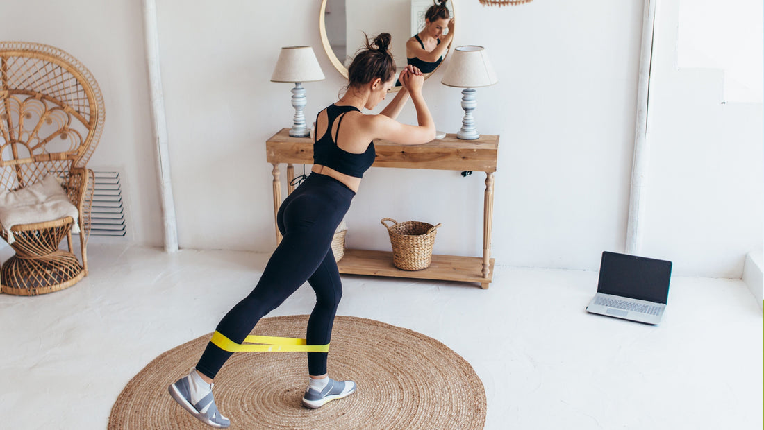 Woman over 40 strength training with resistance bands at home to maintain muscle mass, improve bone health and support healthy aging.