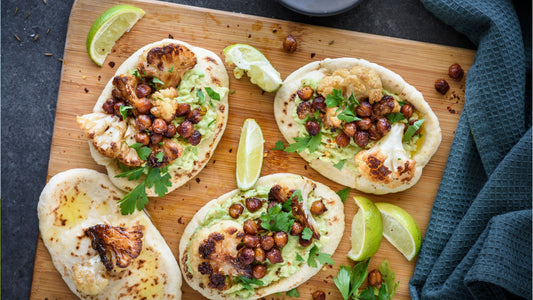 Healthy cauliflower flatbreads with roasted chickpeas, avocado spread and fresh herbs. Easy wholefood recipe featuring fresh seasonal cauliflower and plant-based ingredients.