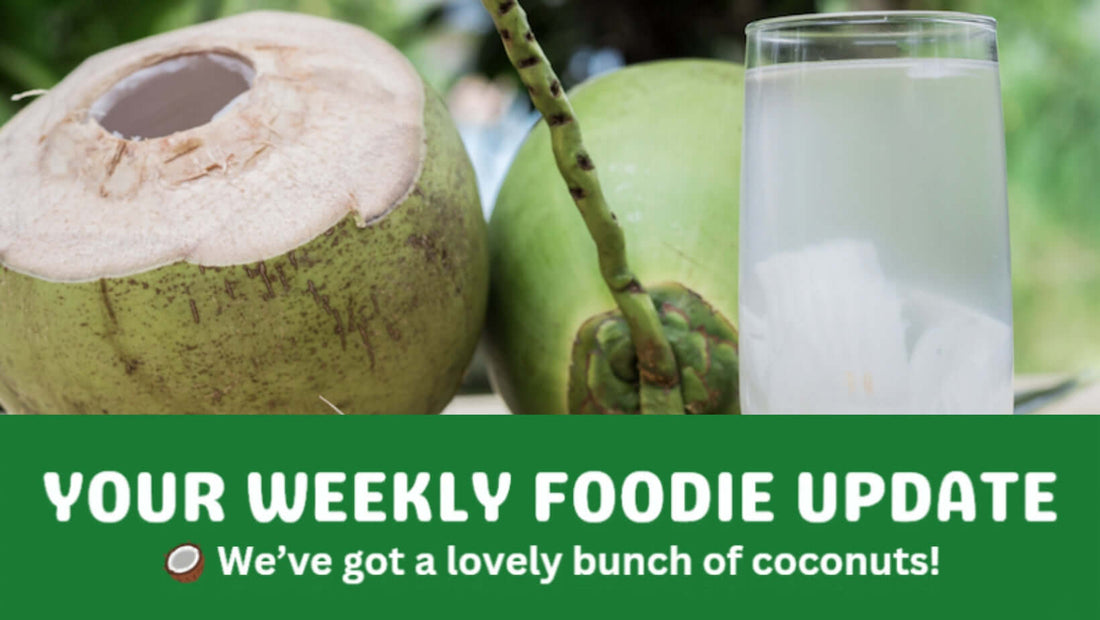 Fresh green coconuts with a glass of coconut water, representing organic food and organic fruit and veg delivery in Brisbane