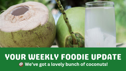 Fresh green coconuts with a glass of coconut water, representing organic food and organic fruit and veg delivery in Brisbane