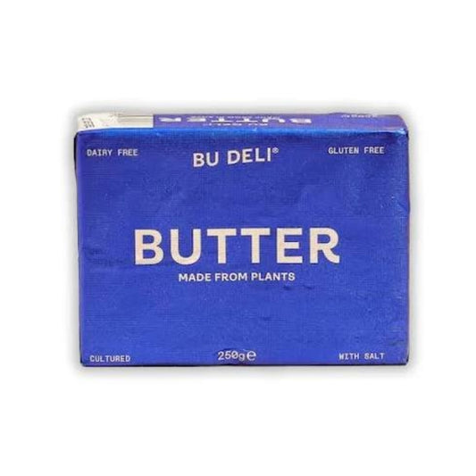A blue rectangular package of BU DELI Butter, made from plants, with white text, shown on a plain white background.