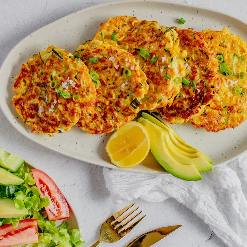 Golden Zucchini Haloumi Fritters, featured in the Joy Wholefoods online store.