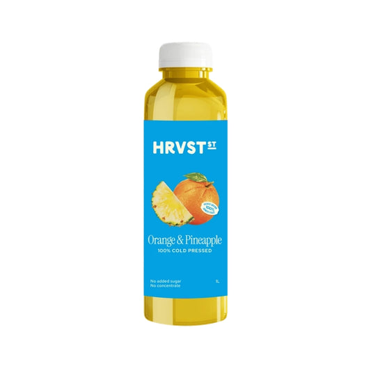 A bottle of HRVST II Orange & Pineapple cold-pressed juice, featuring a bright blue label with orange and pineapple graphics, filled with yellow juice and topped with a white cap, set against a plain white background.
