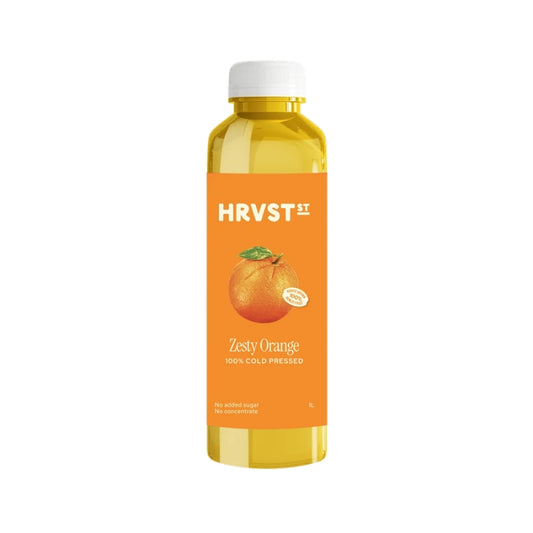 A bottle of HRVST Zesty Orange 100% cold pressed juice, featuring a bright orange label with a graphic of an orange and a white cap, set against a plain white background.