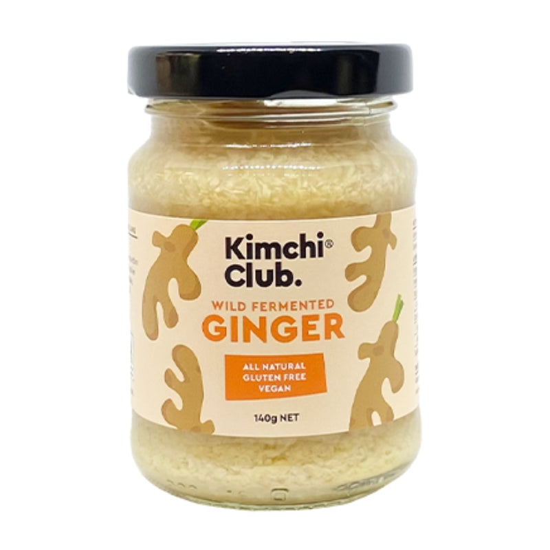 A glass jar of Kimchi Club Wild Fermented Ginger with a black lid and a beige label featuring ginger illustrations, set against a plain white background.