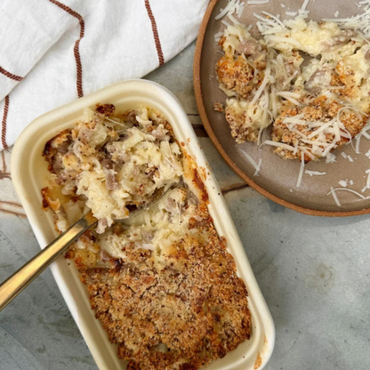 Baked Mac 'n' Cheese (Serves 2) with a scoop taken out, served on a plate with a fork.