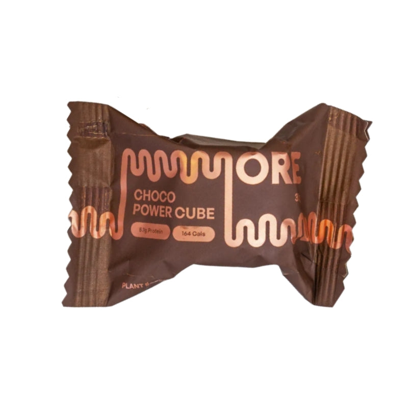A single wrapped protein powder cube in a brown wrapper with copper-colored text reading 'MORE CHOCO POWER CUBE' on a plain white background.