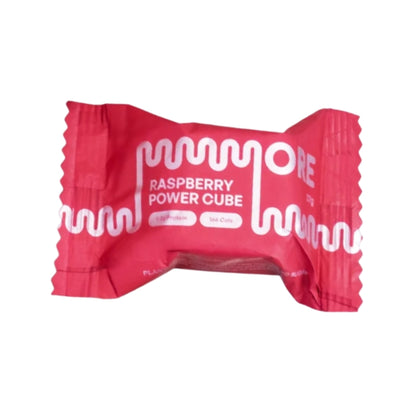 A single wrapped candy bar in bright pink packaging with white text reading 'RASPBERRY POWER CUBE' and a wavy logo, shown on a plain white background.
