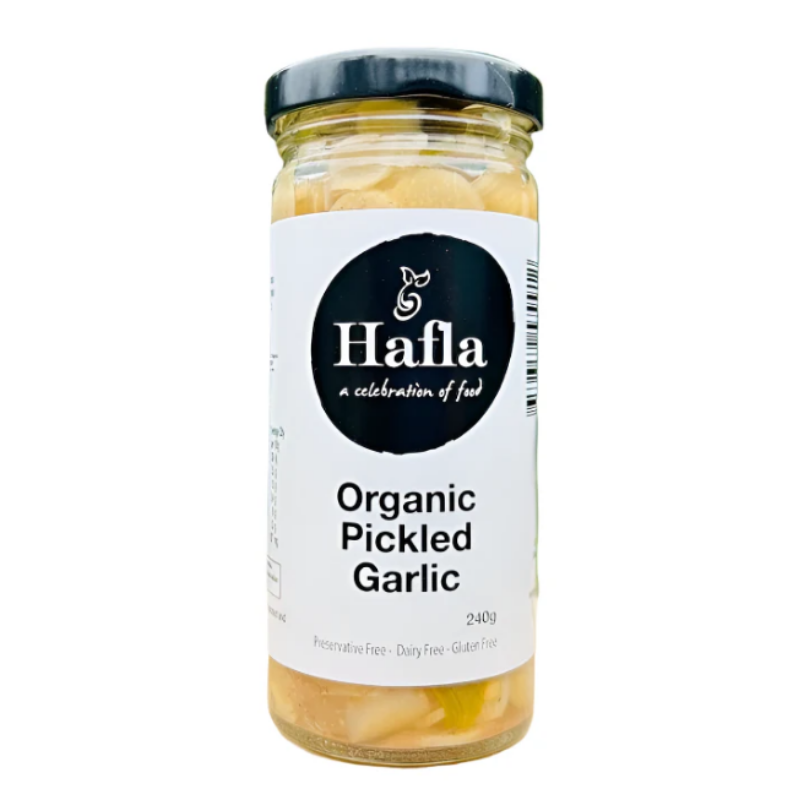 A glass jar of Hafla Organic Pickled Garlic with a white label and black lid, set against a plain white background.