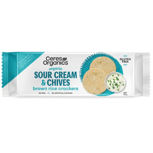 Ceres Organics organic Sour Cream & Chives brown rice crackers in a white and teal wrapper, showing two round crackers and a small bowl of chive dip on a white background.
